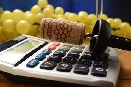 Korkenzieher mit Korken auf Taschenrechner