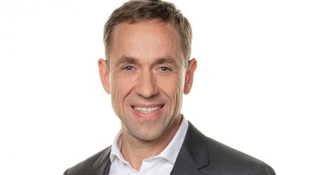 Andre-Karpinski lacht in die Kamera.