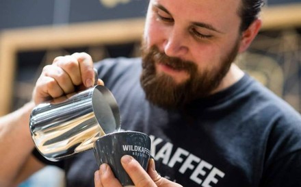 Ein Barista beim Einschenken eines Kaffees