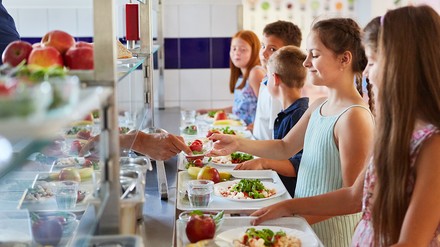 Kinder an der Essensausgabe einer Schulkantine