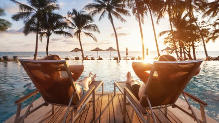 Zwei Touristen auf zwei Liegen am Pool