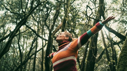 Frau im Wald atmete frische Luft tief ein.