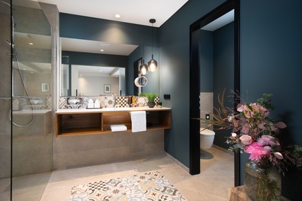 Im Bad kommen natürlich-harmonische Farbtöne mit Echtholz und schönen ornamentalen Fliesen zusammen.