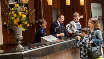 Familie beim Check-in im Hotel