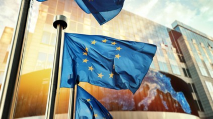 EU flags waving in front of European Parliament building. Brussels, Belgium