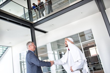 Arabischer Mann schüttelt Geschäftsmann die Hand