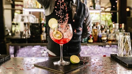 Wirt schüttet Cocktail in ein Glas