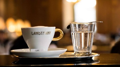 Eine Tasse Kaffee und ein Glas Wasser mit der Aufschrift Landtmann