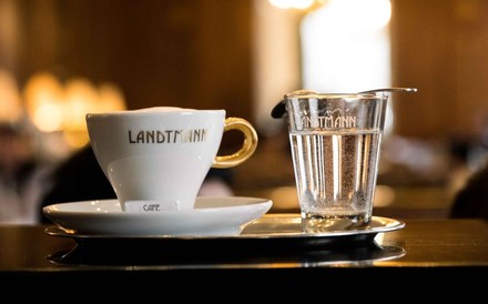 Eine Tasse Kaffee und ein Glas Wasser mit der Aufschrift Landtmann