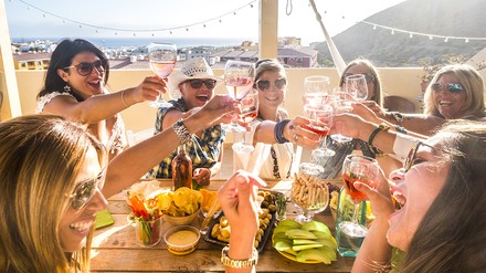 eine Gruppe fröhlicher Menschen beim gemeinsamen Essen