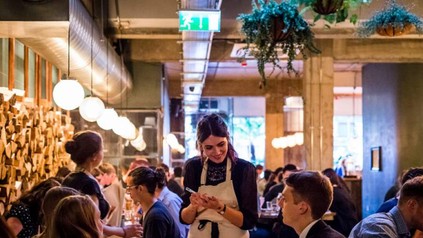 Kellnerin bedient Mann in Restaurant