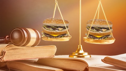 Eine richterliche Waagschale, in der sich zwei Big Macs befinden